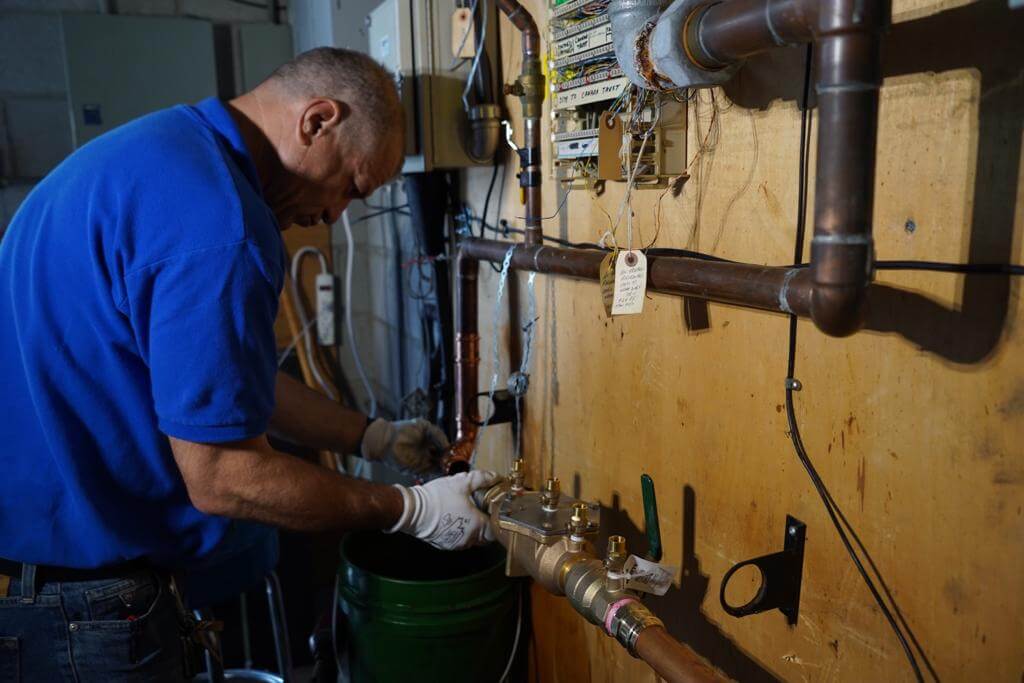 Certified backflow preventer test in progress on a commercial property in Oshawa