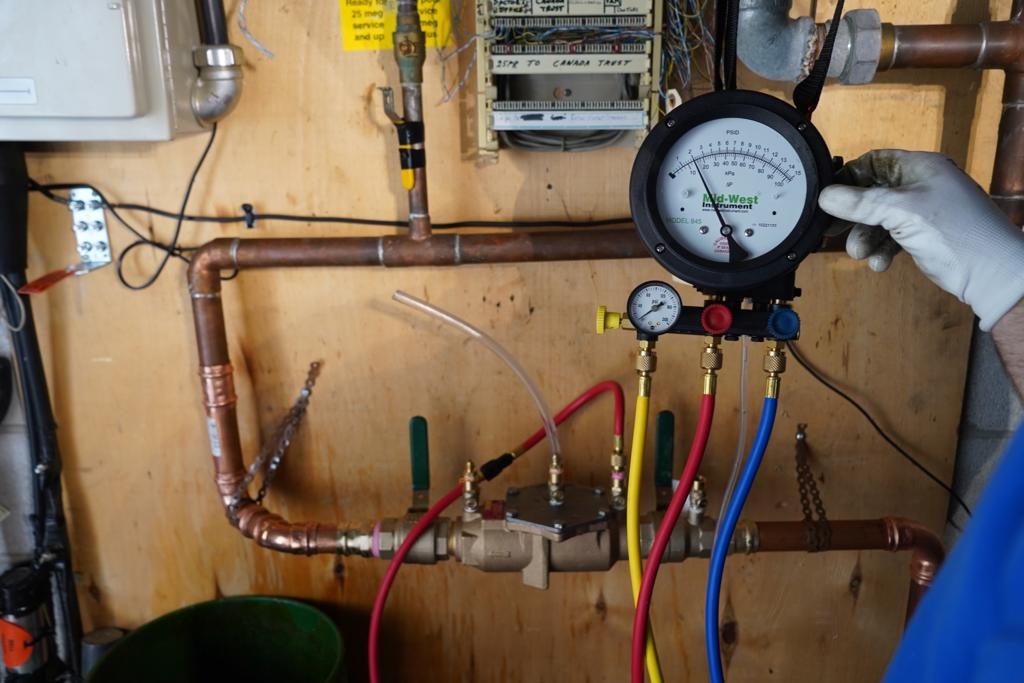 A backflow test gauge connected to a DCVA assembly during an annual test